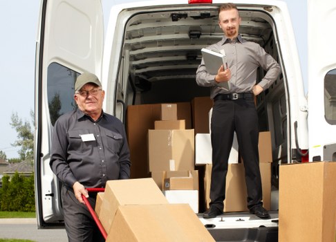 Loading furniture into a Queenspark removal van with careful handling