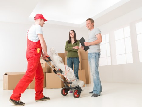 Local Queenspark movers loading furniture into a transport van