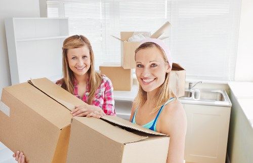 Moving boxes and furniture being loaded into a van